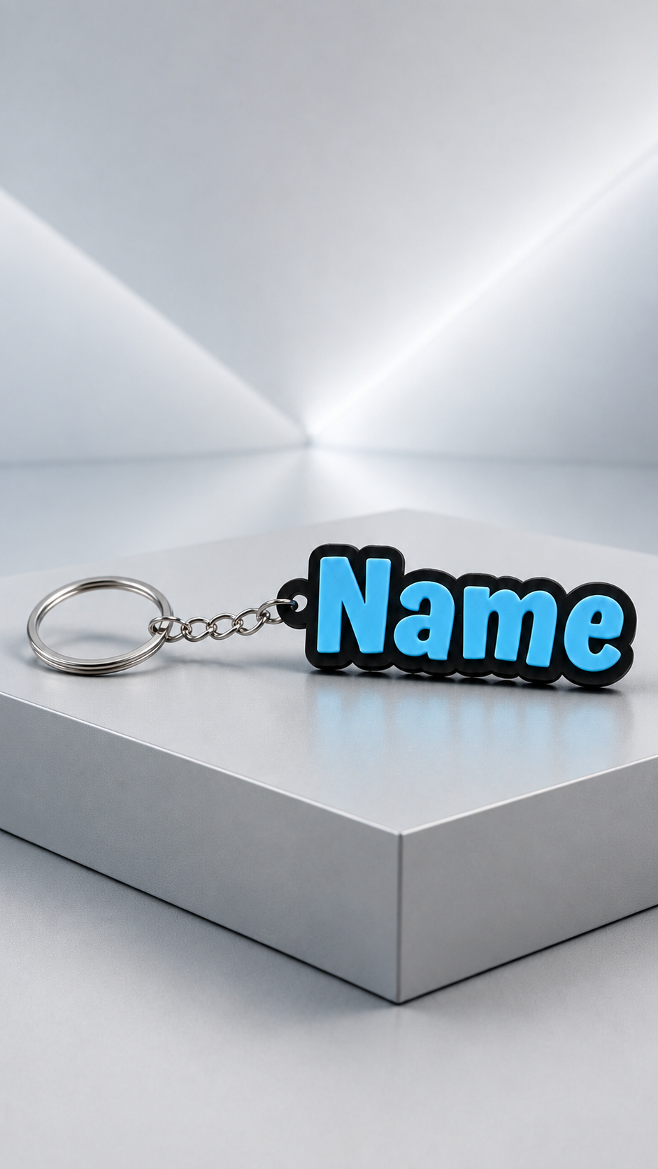 Horizontal view of a personalized name keychain with blue lettering and a silver key ring