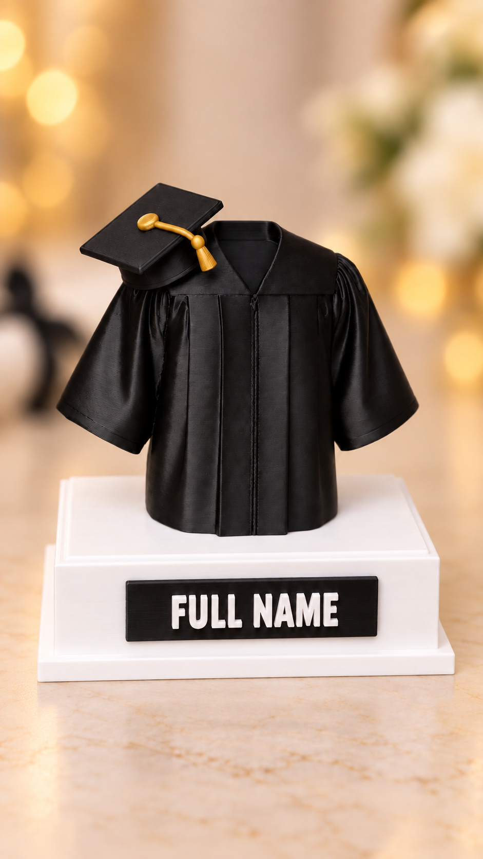 Personalized 3D-printed graduation gown keepsake with gold tassel and custom full-name plaque, front view