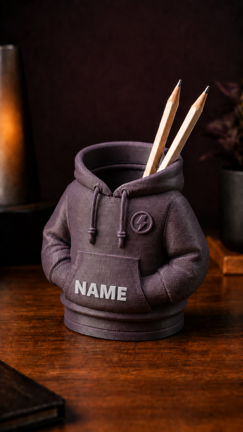 Personalized 3D-printed hoodie pencil holder with custom white name, angled view